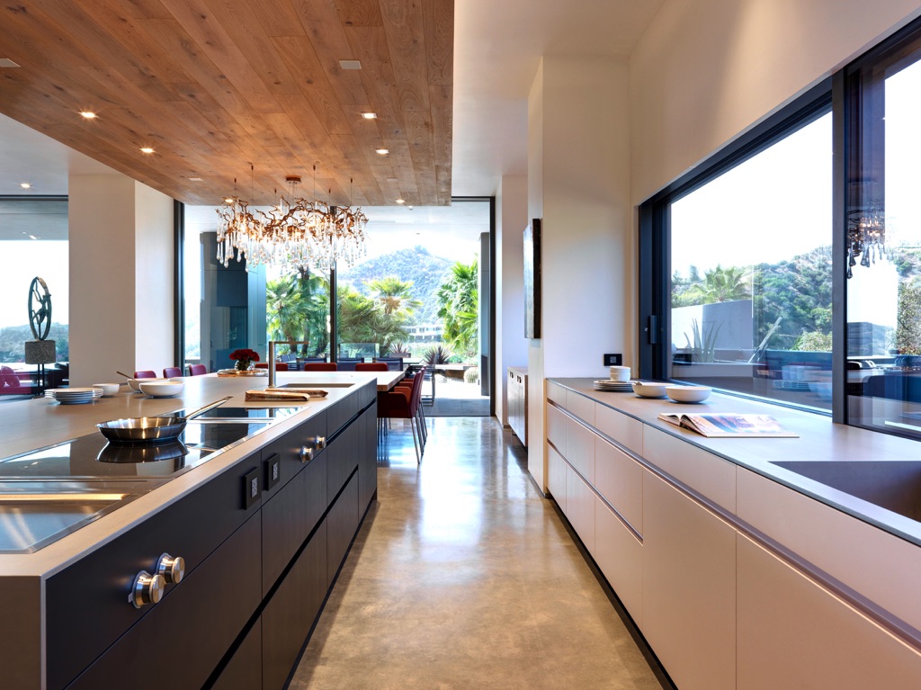 In Schwarz und Grau realisierten die Bauherren in der Küche ein wohnliches und klar strukturiertes Raumambiente mit zentralem Inselblock, inklusive Koch- und Spülmöglichkeit. 