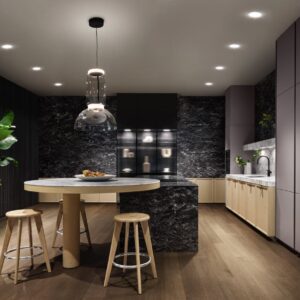 Die Küche aus der Serie „Mondial“ von SieMatic erscheint wie ein Gesamtkunstwerk. Die Insel ist ansprechend gestaltet mit Marmor und Glaselementen. Schön ist das gerundete Ende mit Sitzplatz.