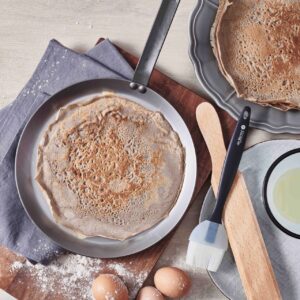 Goldbraun und hauchdünn, so sieht der perfekte Crêpe aus. Zubereiten lässt er sich in einer ganz flachen Pfanne. Ideal ist die „Mineral B Crêpes-Pfanne“. Durch die gute Wärmeleitung des Eisenstahls wird der Teig gleichmäßig ausgebacken. Erhältlich auch im Set mit Holzwender und Silikonpinsel. Von de Buyer, ca. 60 Euro.