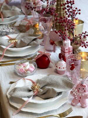 Credit: Chic Antique
Der Tisch präsentiert sich nostalgisch. Dazu trägt das weiße, verschnörkelte Geschirr bei und die kindlichen Accessoires in Form von besonderen Weihnachtsanhängern, wie Cupcakes oder Geschenkpäckchen. Hübsch sind auch die optisch vereisten Beerenzweige und die Paradiesäpfel. Das i-Tüpfelchen sind samtige Schleifen. Alles von Chic Antique. 
