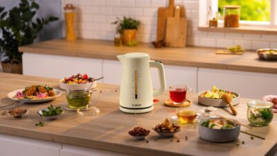 Der Wasserkocher aus der „My Moment“-Serie von Bosch ist genau richtig für frisch aufgebrühten Tee. Man kann darin die passende Menge für eine einzelne Tasse Tee abmessen. Wer mehr Wasser benötigt, das Gerät hat ein Fassungsvermögen bis zu 1,7 Litern Wasser. Der Deckel lässt sich ganz einfach mit einem Druck auf den Knopf am Griff öffnen. Wird der Wasserkocher von der Basisstation genommen, schaltet er sich automatisch aus. Es gibt das Gerät in den Farben Schwarz, Dunkelrot, Beige und Weiß. 
