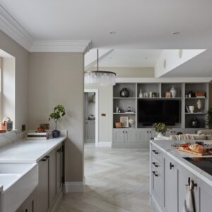 Die Küche im Shaker-Stil steht für das moderne Landhaus. Das helle Grau ist ein derzeit sehr angesagter Ton. Die Keramikspüle, die matte Armatur und die Griffe sind ein Eyecatcher. Letztere sind von Armac Martin.