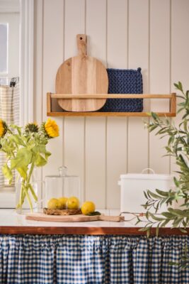 Gelb und Blau ergeben eine geschmackvolle Kombi und verbreiten südliches Flair in der Küche. Eine tolle Idee ist es, einen Vorhang statt Küchenfronten zu wählen, das lässt das ganze Jahr über Urlaubsstimmung einziehen. Alle Accessoires sind von Ib Laursen.