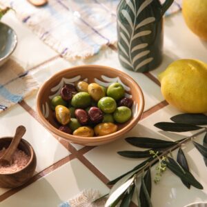 Oliven gibt es in den unterschiedlichsten Ausführungen, zum Beispiel mit Mandeln oder Knoblauch. Sie schmecken am besten zu Brot. Accessoires im südlichen Uraubslook findet man bei von Søstrene Grene. 
