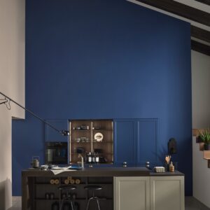 Na, haben Sie die Schränke an der Wand auf den ersten Blick entdeckt? Die blaue Wand schluckt sie regelrecht, denn Fronten und Wand haben den gleichen Farbton. Bei den Fronten „Ravenna Lack“ heißt die matte Nuance „Blaubeere“, an der Wand ist sie aus der Schöner Wohnen Kollektion. Hübsch ist auch der Greige-Ton der Insel.
