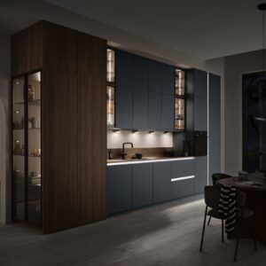 Holz trifft auf dunkelgraue, seidenmatte Fronten und Glas, in Szene gesetzt mit einem durchdachten LED-Lichtkonzept. Beleuchtet werden die waagrechten und senkrechten Griffleistenbeleuchtungen sowie die kleinen und großen Glasvitrinen. Ein gelungenes Gesamtensemble.